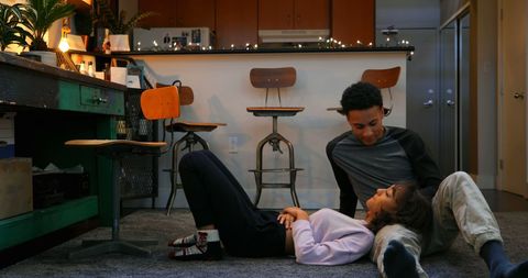 Couple relaxing at home with smartphone on cozy evening