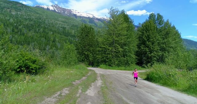 Woman jogging on a scenic mountain trail, with copy space. Outdoor exercise brings both physical and mental benefits amidst nature.