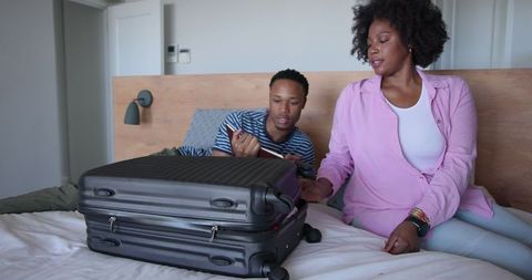 Couple Excitedly Packing for Vacation