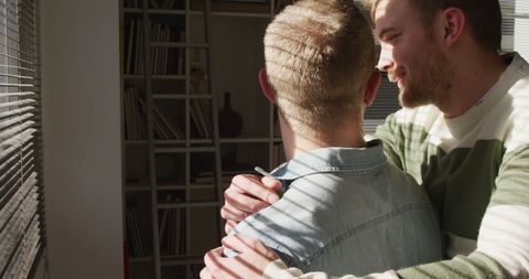 Affectionate Couple Embracing in Sunlit Living Room