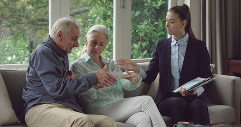Senior Couple Discussing Legal Documents with Advisor at Home