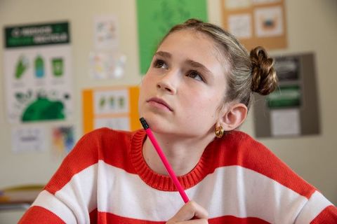 Pensive Student Gazing in Class with Recycling Theme