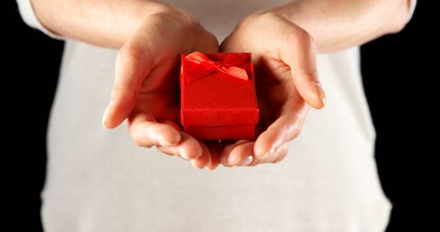 Close-up of Hands Holding Small Red Gift Box with Ribbon - Download Free Stock Images Pikwizard.com