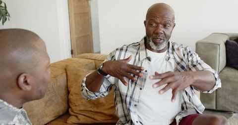 Father engaging in heartfelt discussion with friend at home