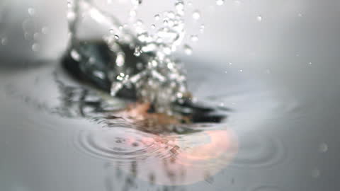 Splashing Apple Dropping into Water in Slow Motion
