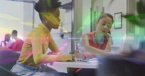 Two Diverse Colleagues Collaborating in Modern Office Environment