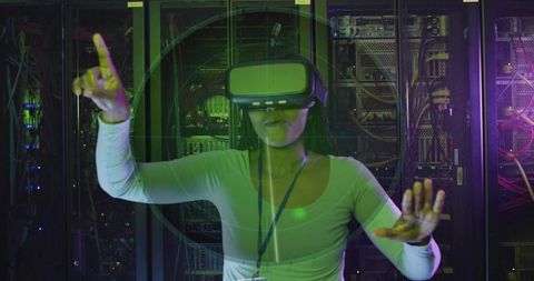 Woman Interacting with Virtual HUD in Server Rack Using VR Headset and Neon Interface