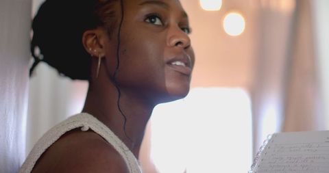 Woman reading notes indoors focusing on literature study