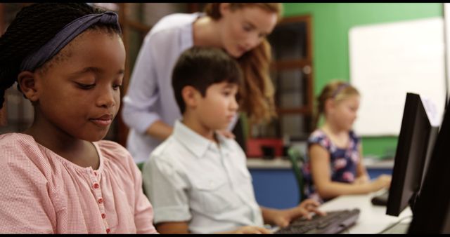 Teacher Assists Focused Students on Computers in Classroom - Download Free Stock Images Pikwizard.com