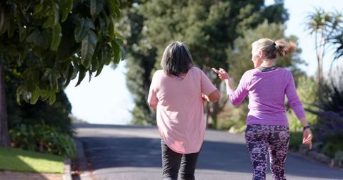 Female Friends Walking in Vibrant Outdoors in Athletic Wear
