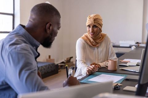 Diverse coworkers in office discussion promoting teamwork