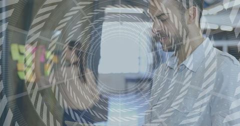 Coworkers discussing ideas over sticky notes on glass wall with spiral overlay