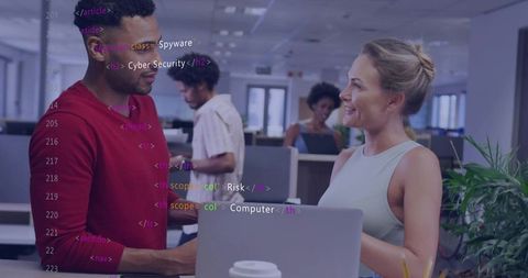 Coworkers collaborating over laptop with code overlay in modern open-plan office
