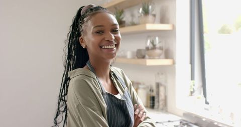 Happy Woman with Braided Hair in Modern Kitchen
