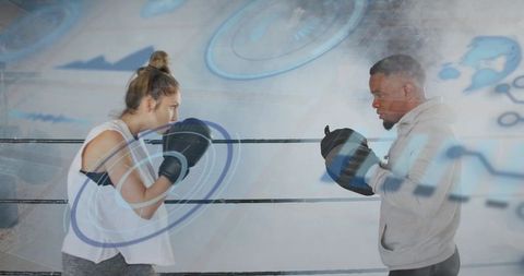 Female boxer training with coach using augmented hud mitts and performance analytics