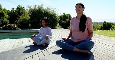 Mother Daughter Meditation Outdoor by Pool Promoting Family Wellness