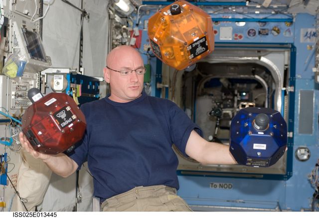ISS025-E-013445 (9 Nov. 2010) --- NASA astronaut Scott Kelly, Expedition 25 flight engineer, is pictured near three Synchronized Position Hold, Engage, Reorient, Experimental Satellites (SPHERES) floating freely in the Kibo laboratory of the International Space Station.