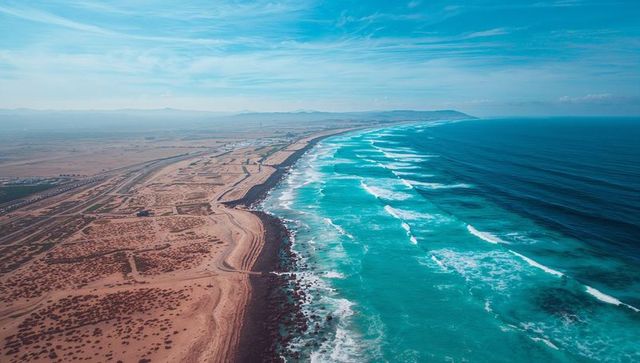 Aerial View of Ocean Waves Crashing on Desert Shoreline