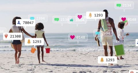 Family walking on beach carrying buckets cooler towels with social media alerts overlays