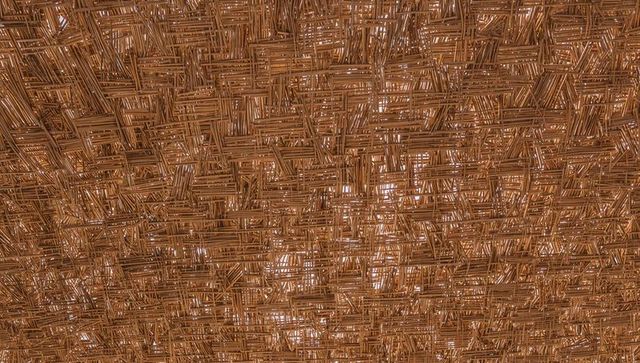 Woven bamboo thatch ceiling with light gaps, rustic rattan lattice texture and pattern