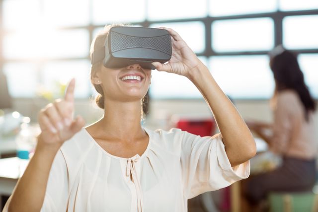Female graphic designer using the virtual reality headset at office