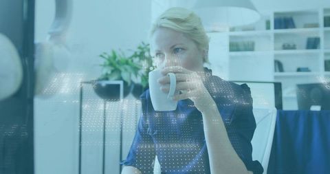 Sipping coffee, viewing digital data overlay in minimalist office, contemplative professional