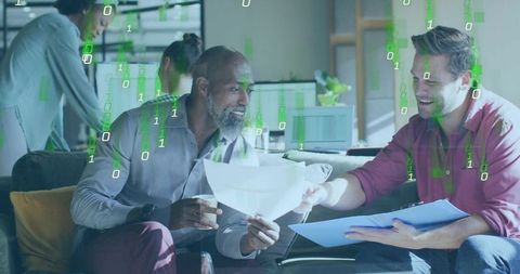 Business Colleagues Discussing Data with Digital Overlay in Modern Office Lounge