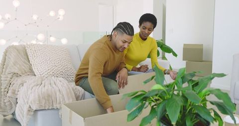 Couple Unpacking Box in Modern Living Room