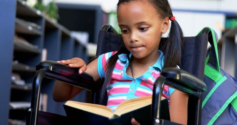 Young African American Girl in Wheelchair Reading Book in Library - Download Free Stock Images Pikwizard.com