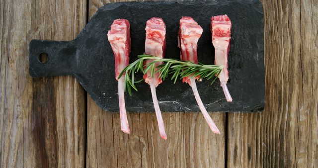 Raw Lamb Chops with Rosemary Sprigs on Rustic Cutting Board - Download Free Stock Images Pikwizard.com