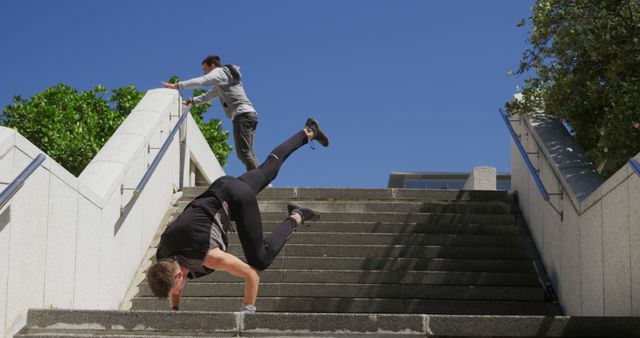 Two Athletes Training Parkour on Urban Stairs in Daylight - Download Free Stock Images Pikwizard.com