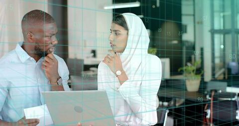 Multicultural Professionals Analyzing Data in Modern Office