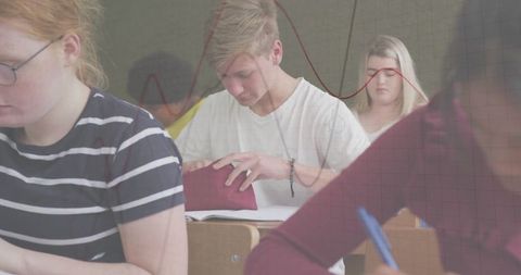 Teen student engaged in classroom activity with stationery