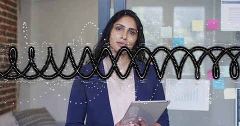 Professional woman analyzing data on tablet at modern office