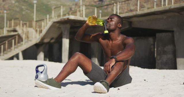 Athletic Man Hydrating on Beach After Workout - Download Free Stock Images Pikwizard.com