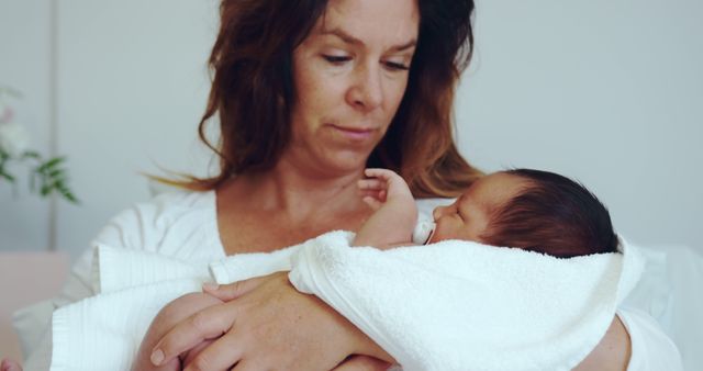 Mother Cradling Newborn Baby in Hospital - Download Free Stock Images Pikwizard.com