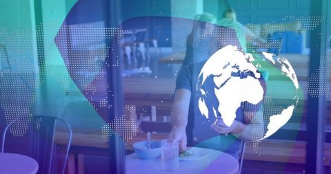 Man dining with digital world overlay in modern cafe