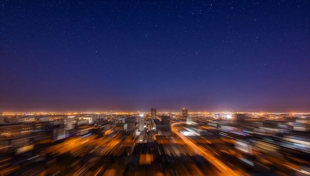 City skyline at night with blurred motion and starry sky