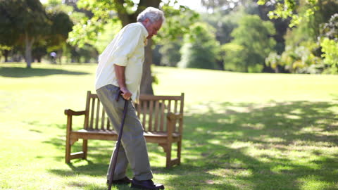 Senior Man Joyfully Dancing in Sunlit Park