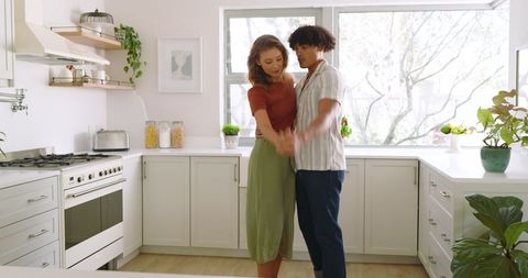 Romantic Couple Dancing in Modern Bright Kitchen Setting