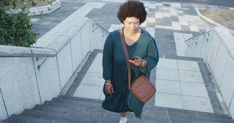 Plus size digital nomad ascending stairs in urban environment