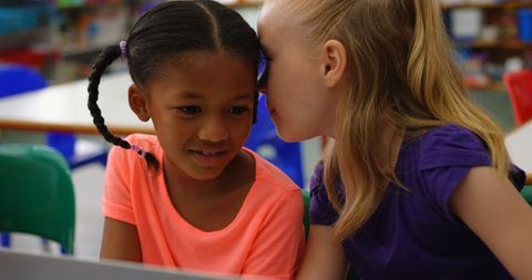 Diverse Friends Learning Together with Laptop in Classroom
