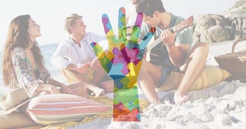 Group Relaxing on Beach with Guitar and Picnic