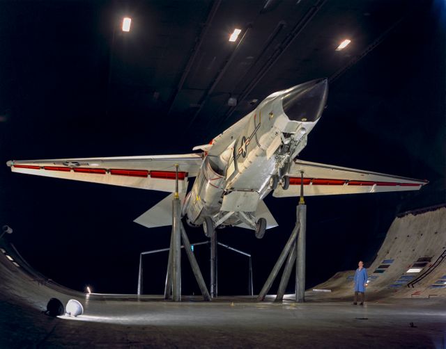 The image features the General Dynamics/Grumman F-111B fighter aircraft with variable swept wings, landing gear down, conducted during slat experiments. The F-111B, developed in the 1960s, was intended to be a carrier-based interceptor for the United States Navy as part of the Tactical Fighter Experimental project. This stock photo is ideal for use in articles related to military aviation history, aircraft design and development, or features on the evolution of fighter aircraft technologies.