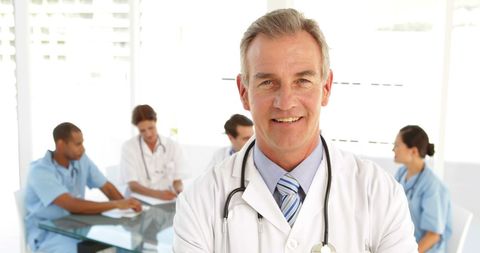 Confident Doctor with Team in Hospital - Download Free Stock Images Pikwizard.com