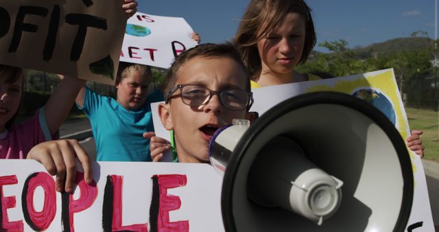 Group of Children Protesting with Megaphone and Signs Outdoors - Download Free Stock Images Pikwizard.com