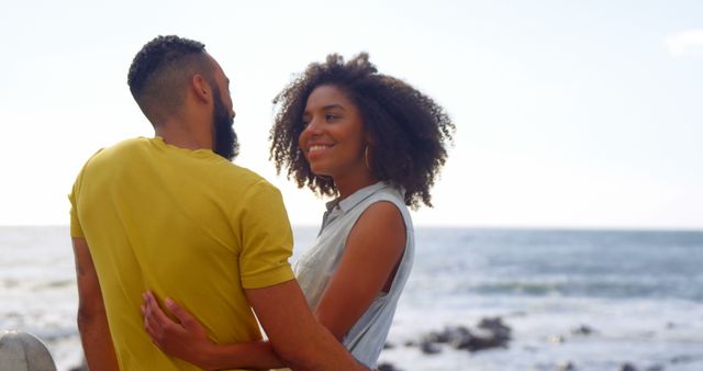 Romantic diverse couple embracing and talking on sunny promenade, copy space. Summer, vacation, romance, love, relationship, free time and lifestyle, unaltered.