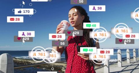 Holding coffee and scrolling smartphone on seafront with floating social media notifications