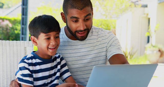 Smiling Father and Son Using Laptop Outdoors - Download Free Stock Images Pikwizard.com