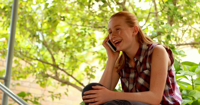 Teenage Girl Laughing While Talking on the Phone Outdoors - Download Free Stock Images Pikwizard.com